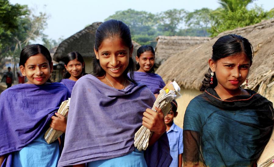 Picture of school girls walking with books. 