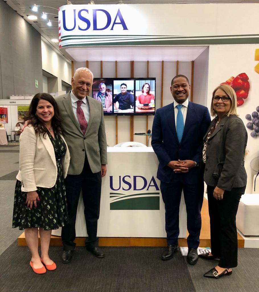 Four individuals at USDA trade show booth