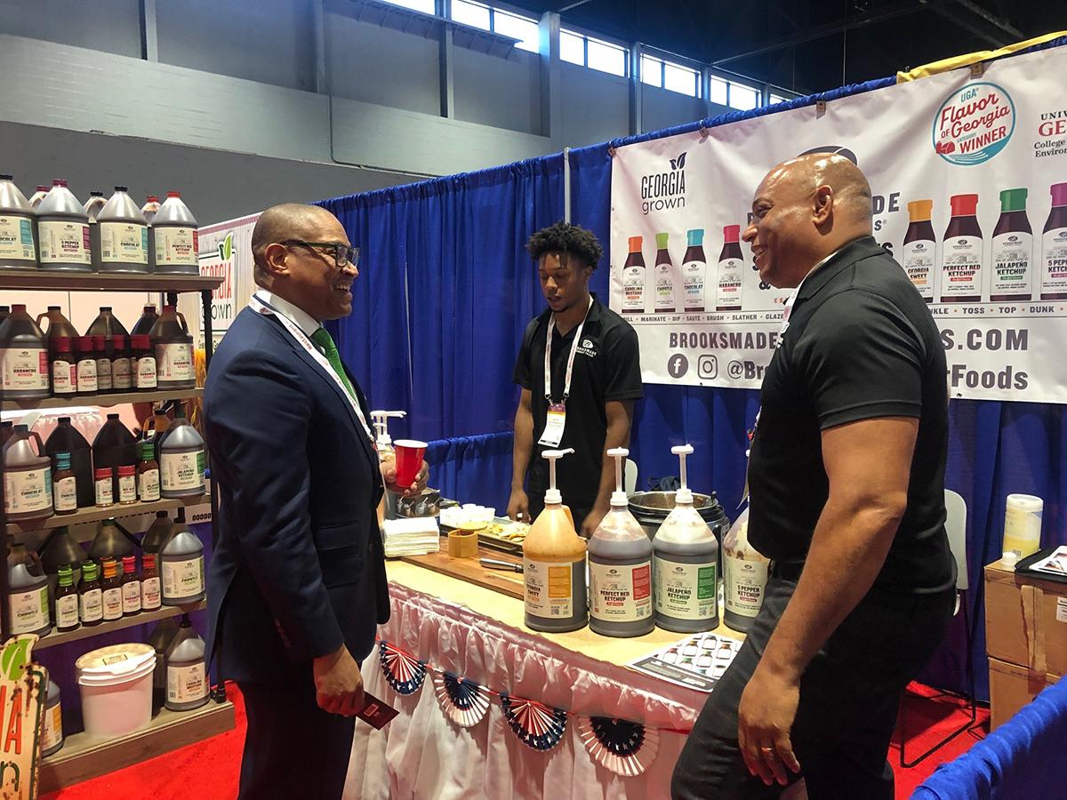 FAS Administrator Daniel Whitley (left) reunites with Walter Brooks (right) of Brooksmade Gourmet Foods after meeting in February during the USDA Agribusiness Trade Mission to Dubai, where Brooks executed a contract—a testament to the success of international trade shows and missions. 