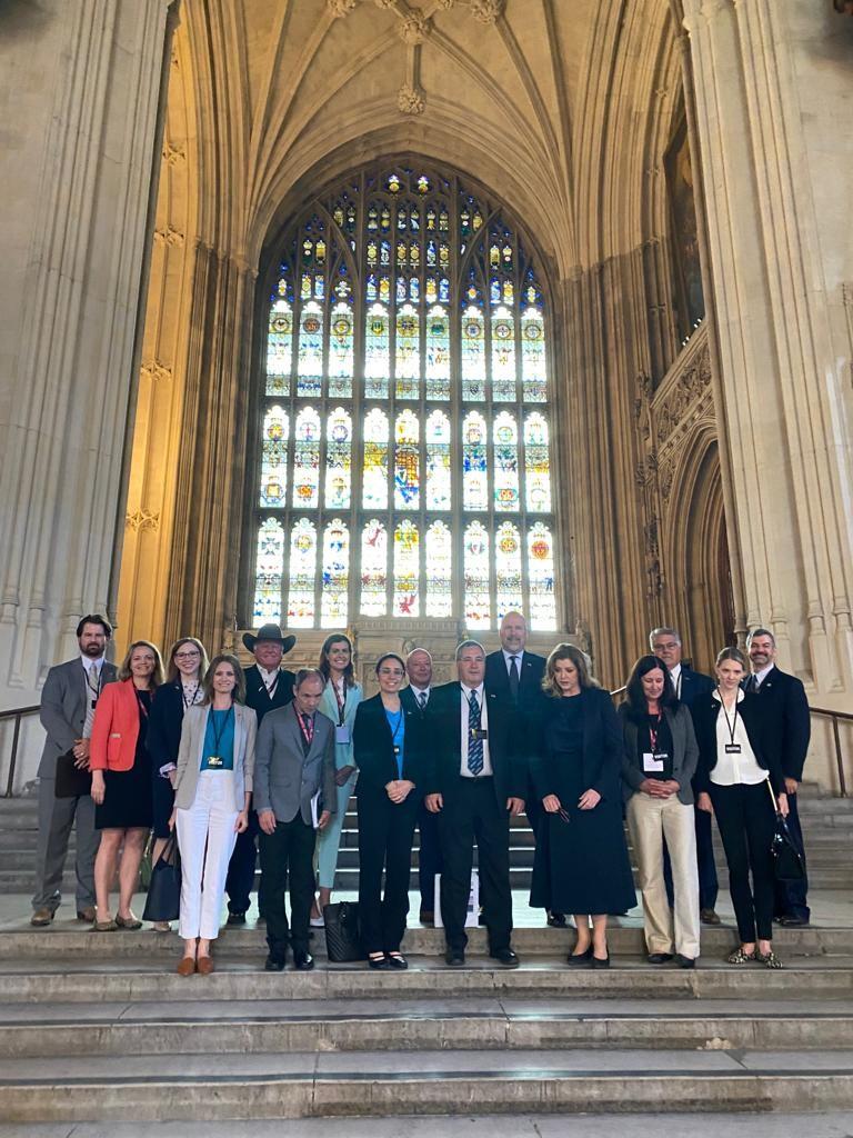 Group in front of stained glass window at Parliament buiilding