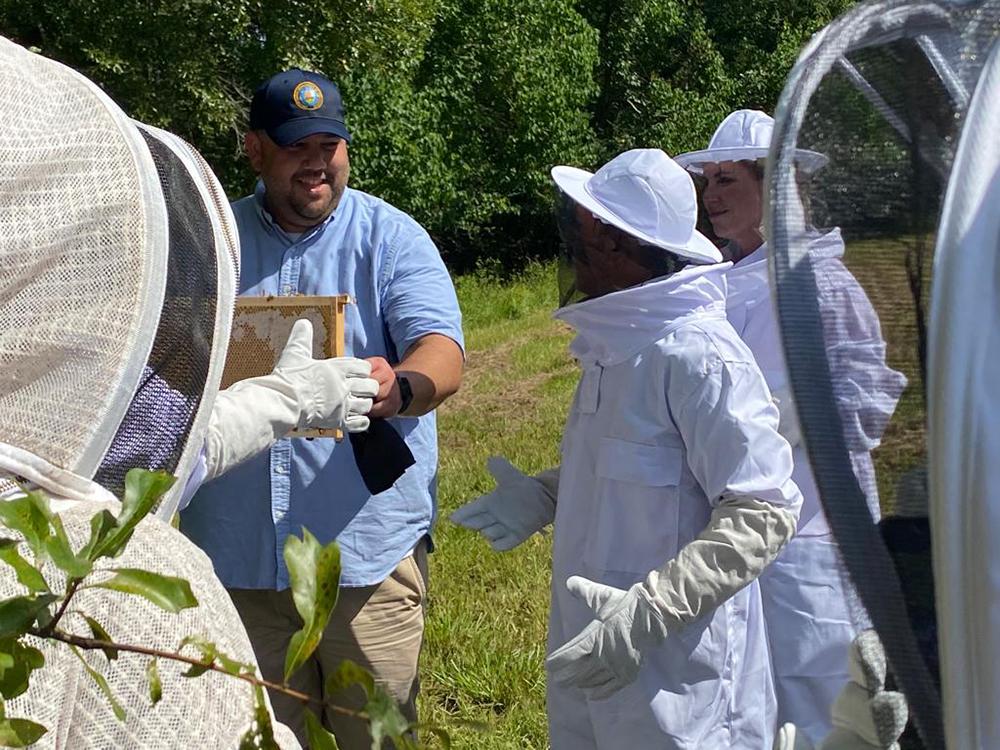 Rishan Chaudhry, Foreign Service Officer Trainee, and FAS overseas staff view honeycomb production at St. Joseph’s Abbey Apiary in St. Benedict, LA.