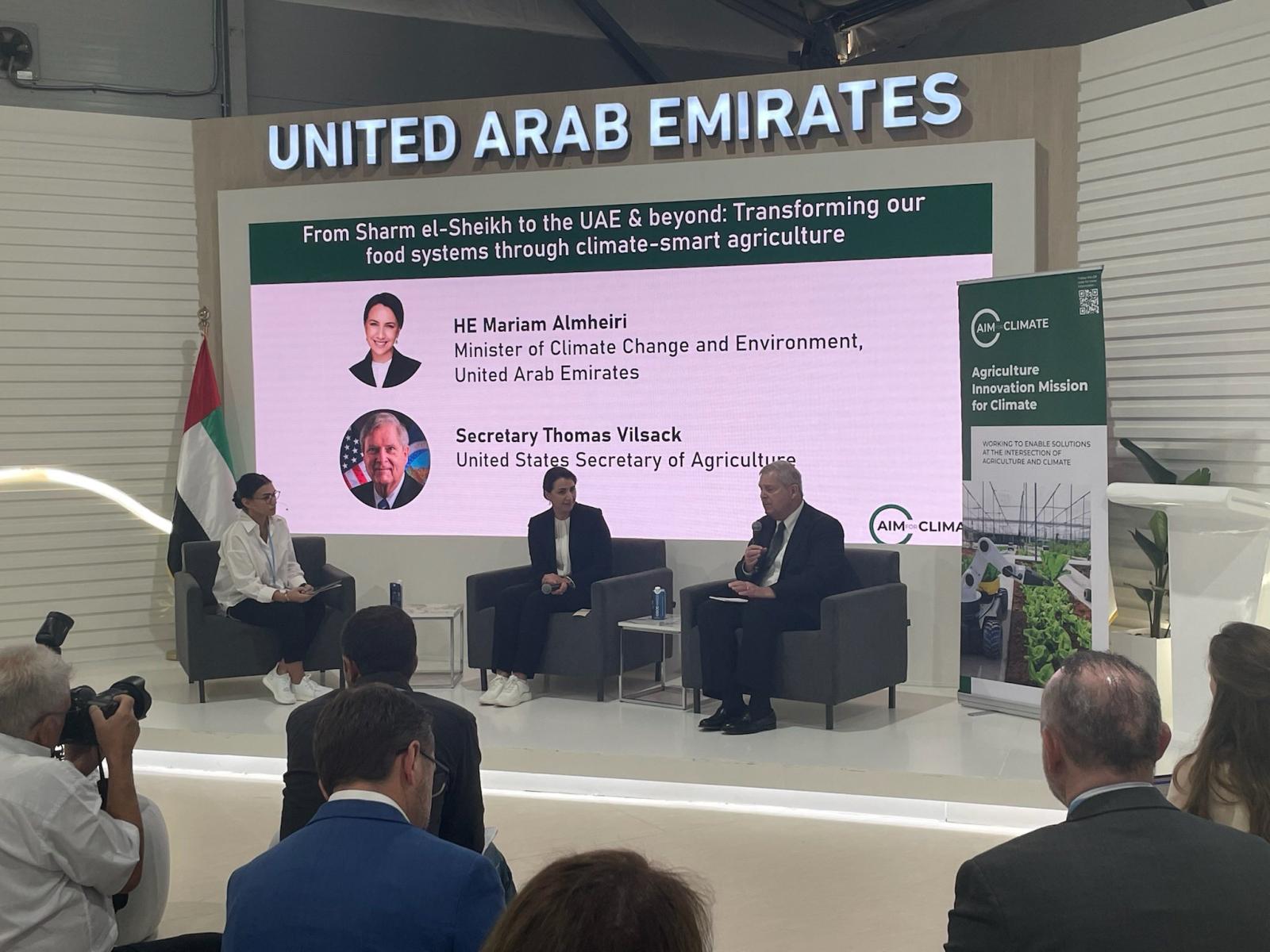 Vilsack seated on stage with two UAE climate leaders.