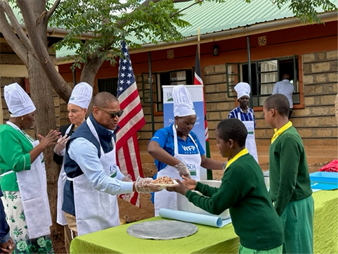 FAS Administrator Daniel Whitley serves meals to school children at Kilimani Primary School in Kenya.