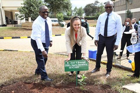 Deputy Secretary Dr. Jewel Bronaugh plants a macadamia nut tree at the Sasini Coffee and Macadamia Nut Processing Center, one of the top suppliers of coffee and macadamia nuts to the United States.