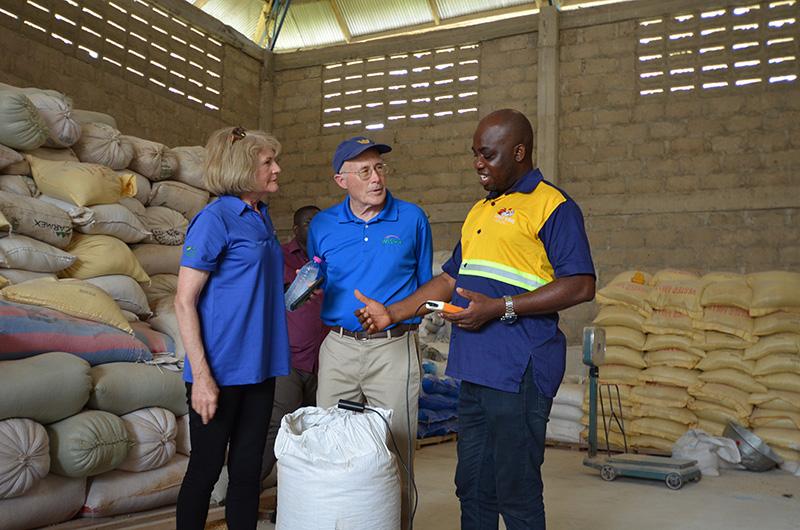 From left, WISHH Chair Roberta Simpson-Dolbeare, WISHH Treasurer Bob Haselwood and Ghanaian poultry farmer Mathew Bonso discuss how Bonso continues to test the moisture of the grains in the feeds he produces for his flock. Grain quality testing is one of the practices that Bonso adopted after learning new poultry production techniques from WISHH’s USDA Food for Progress project.