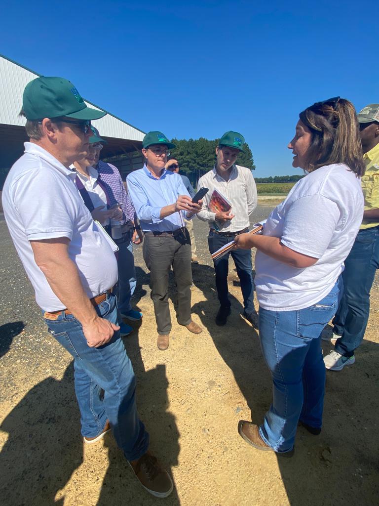 Members of a South America delegation circle around and discuss of the practices they learned about at Hutchison Brothers Farm. 