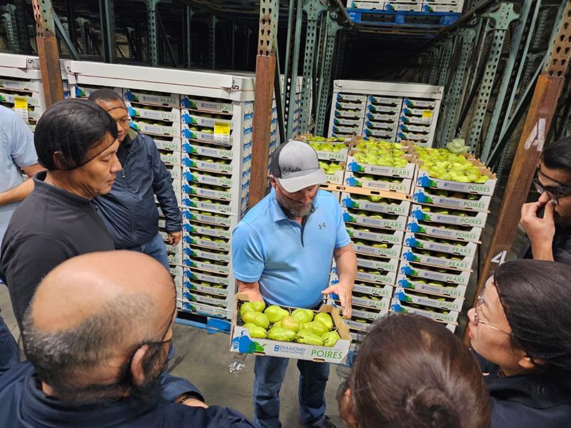 The attachés learning about Oregon’s pear industry at Diamond Fruit Growers in Oregon’s Hood River Valley.