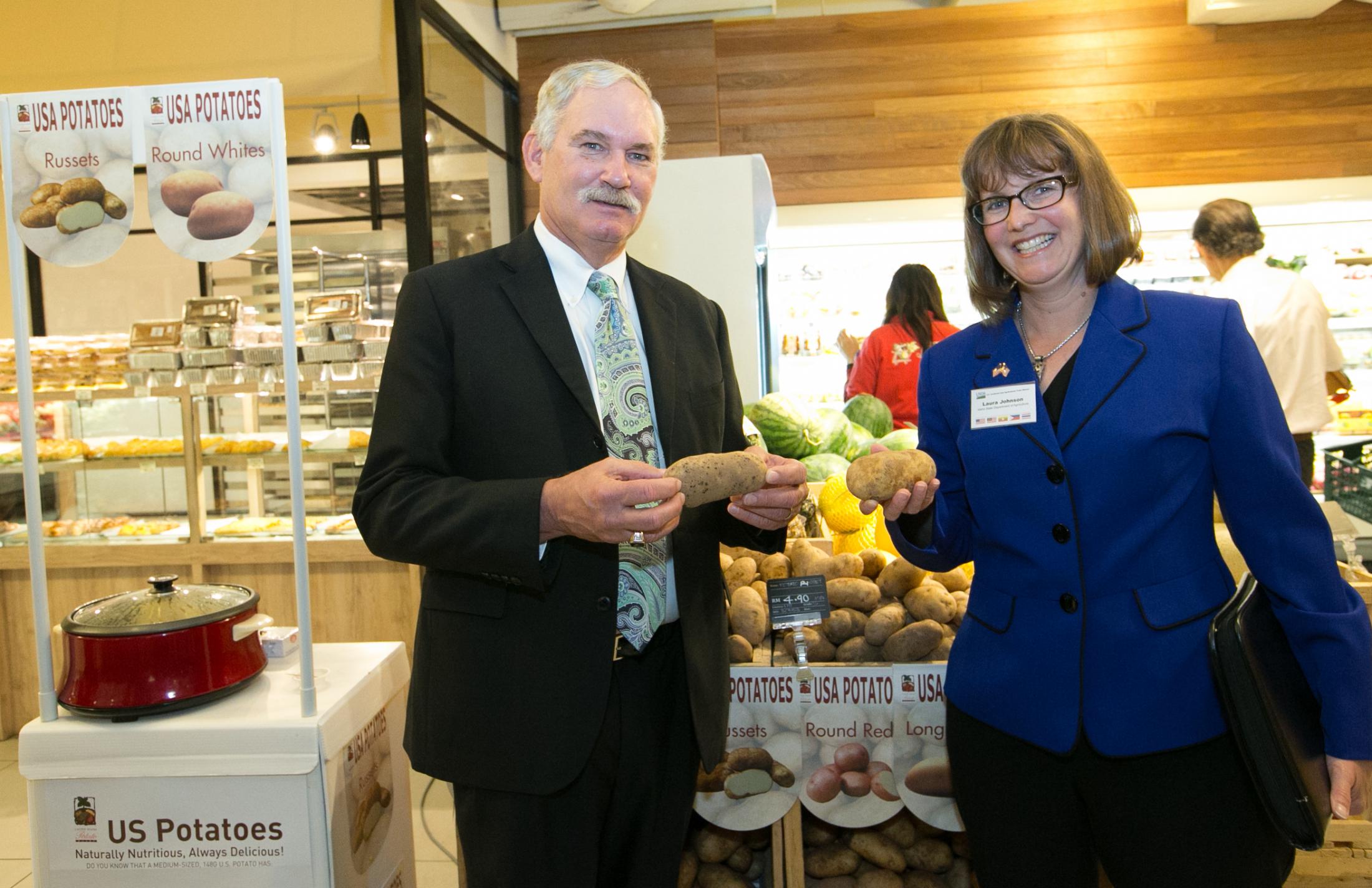 Under Secretary Michael Scuse and Laura Johnson, Bureau Chief for Market Development in Idaho's Department of Agriculture, look at U.S. potatoes on display at Jaya Grocer, a retail market in Kuala Lumpur, Malaysia.