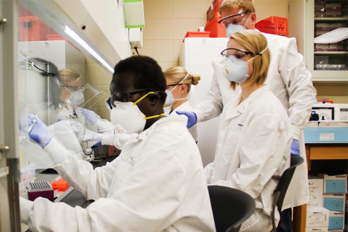 Borlaug fellow Stella Atim of Uganda (left) studies tissue samples in the lab at the University of Wyoming.